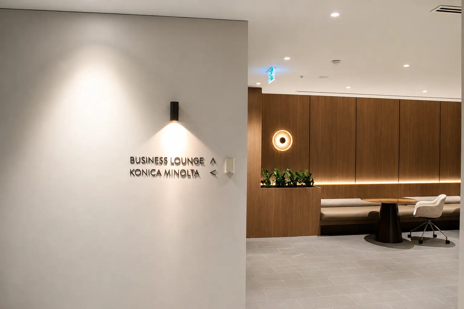 Business lounge wayfinding and timber-lined seating at 616 St Kilda Road