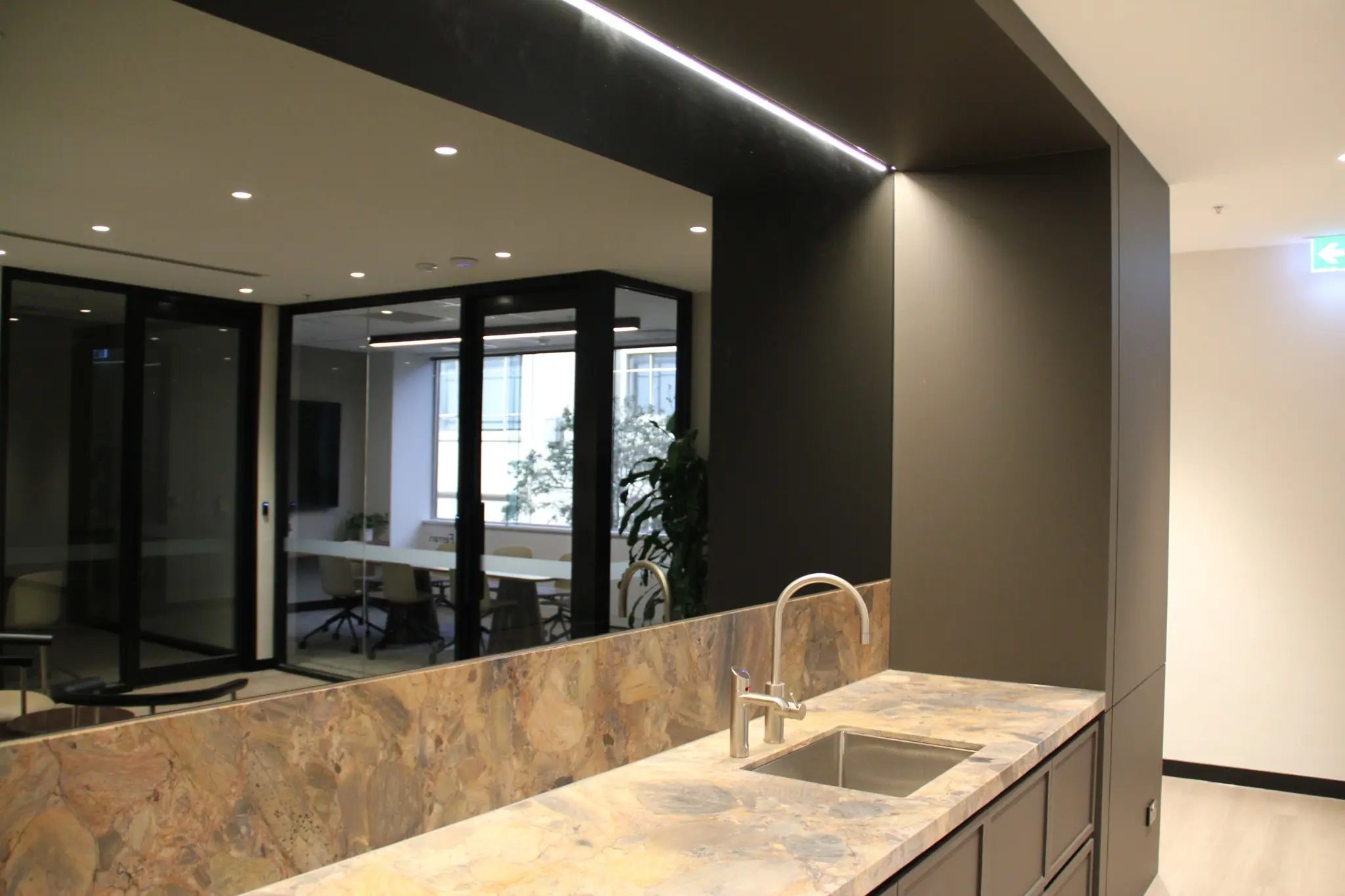 Stone kitchenette and mirrored joinery in the 616 St Kilda Road business lounge