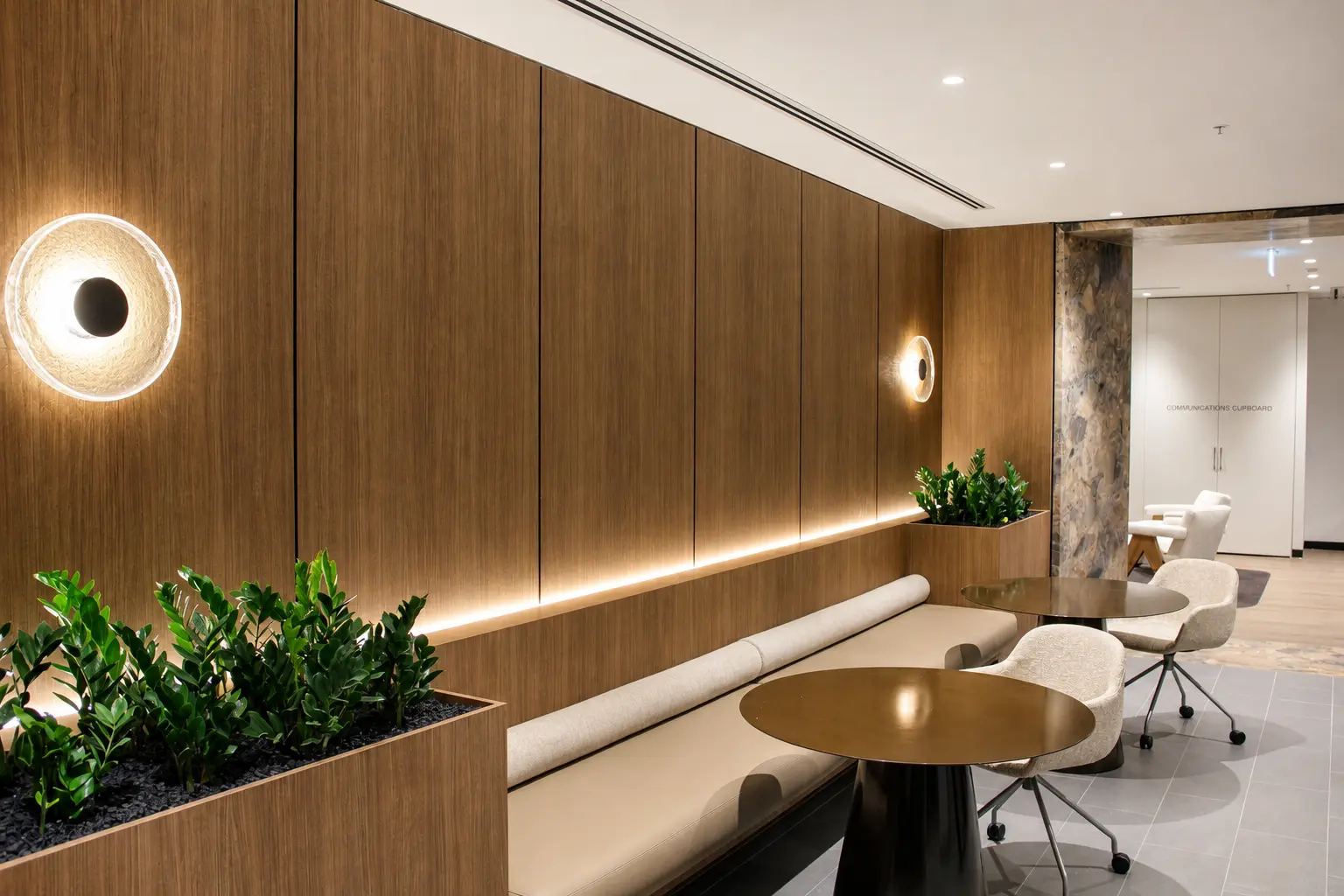 Timber-lined banquette with integrated lighting and planting