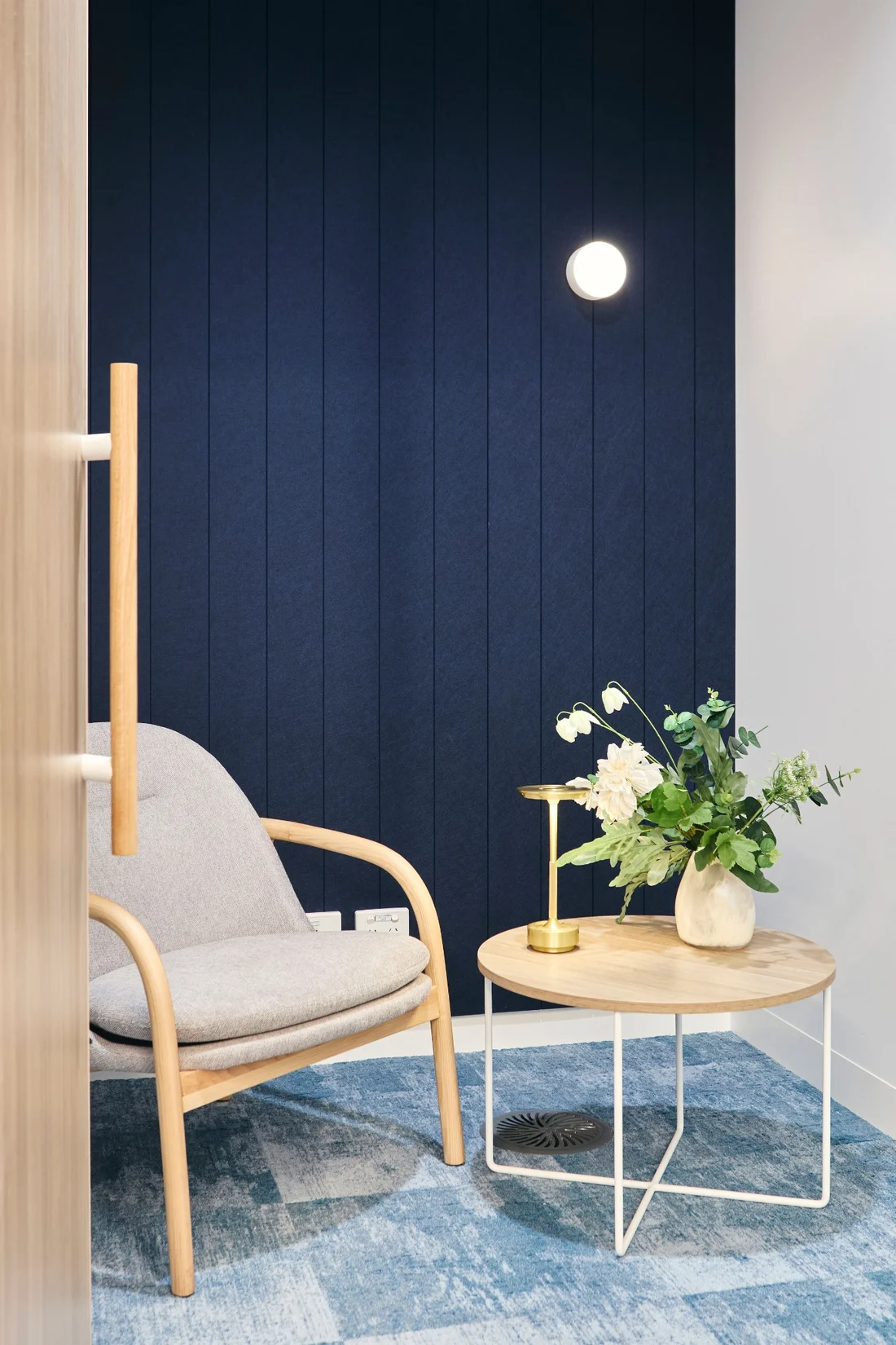 Level 9 quiet room with navy acoustic wall, timber detailing and soft furnishings
