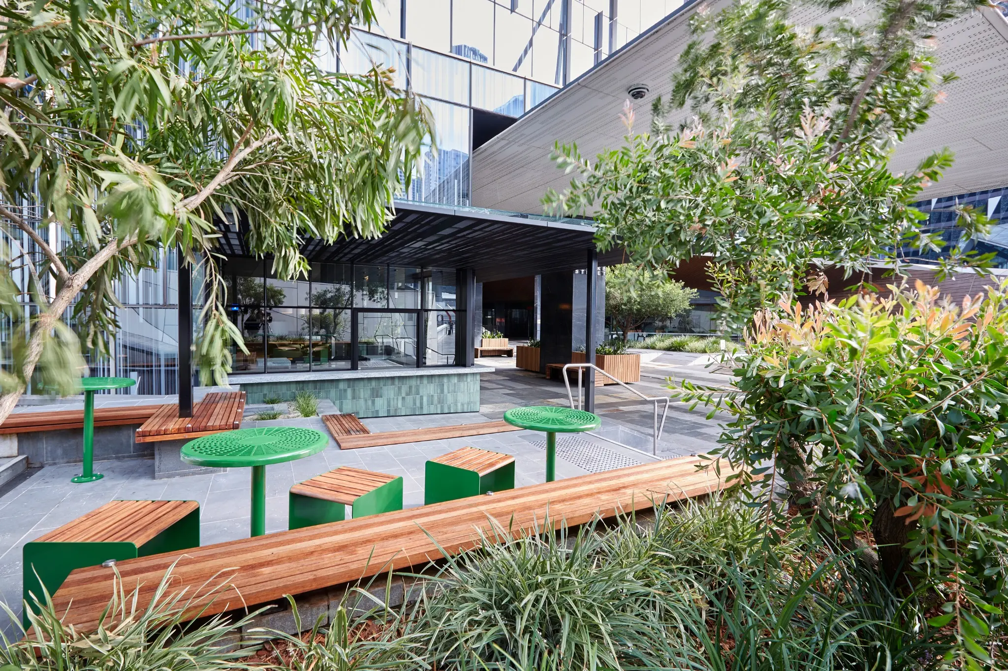 Landscaped external plaza at 717 Bourke Street with integrated seating and planting