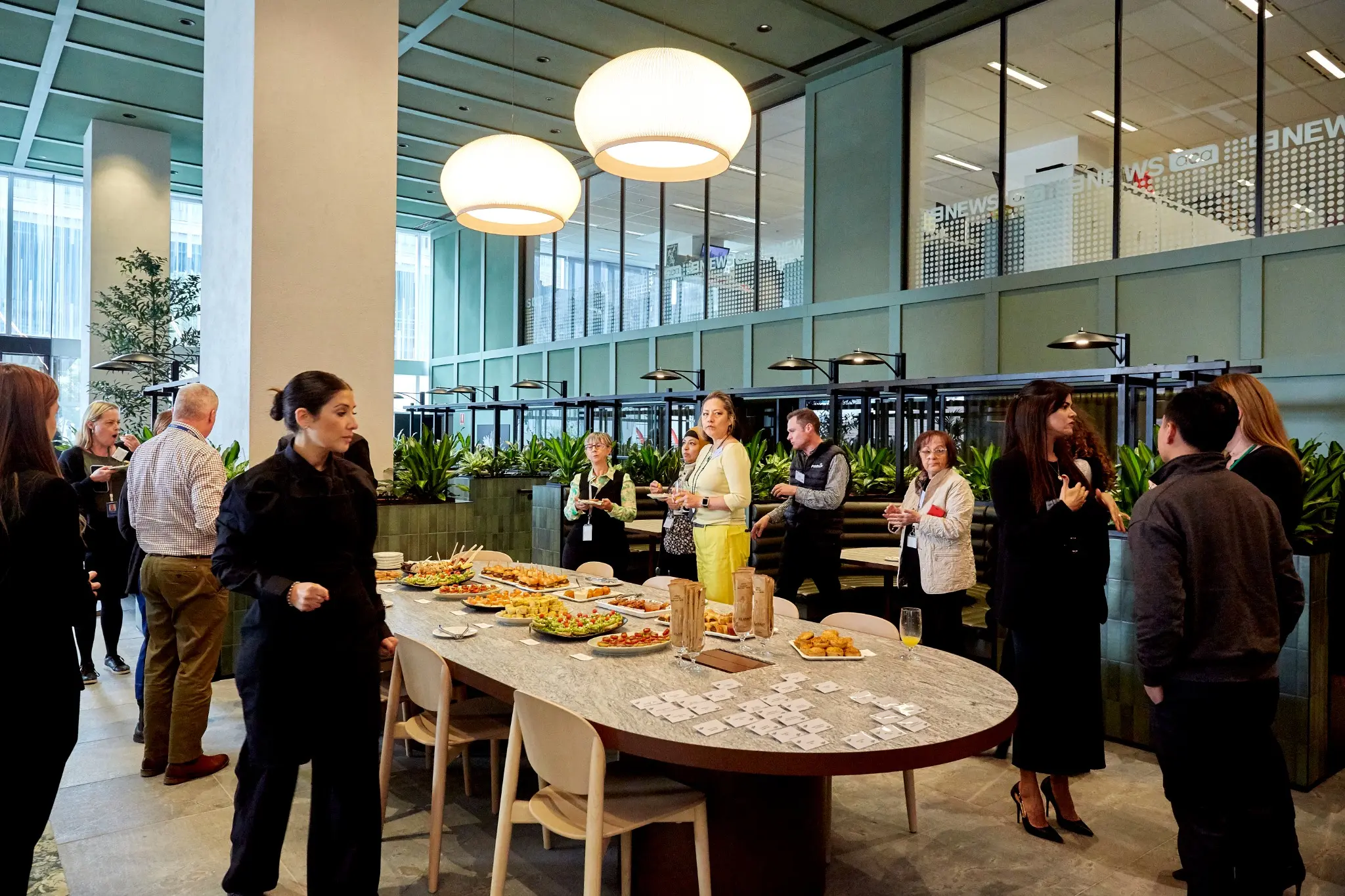 Guests using the hospitality and business lounge at the 717 Bourke Street opening