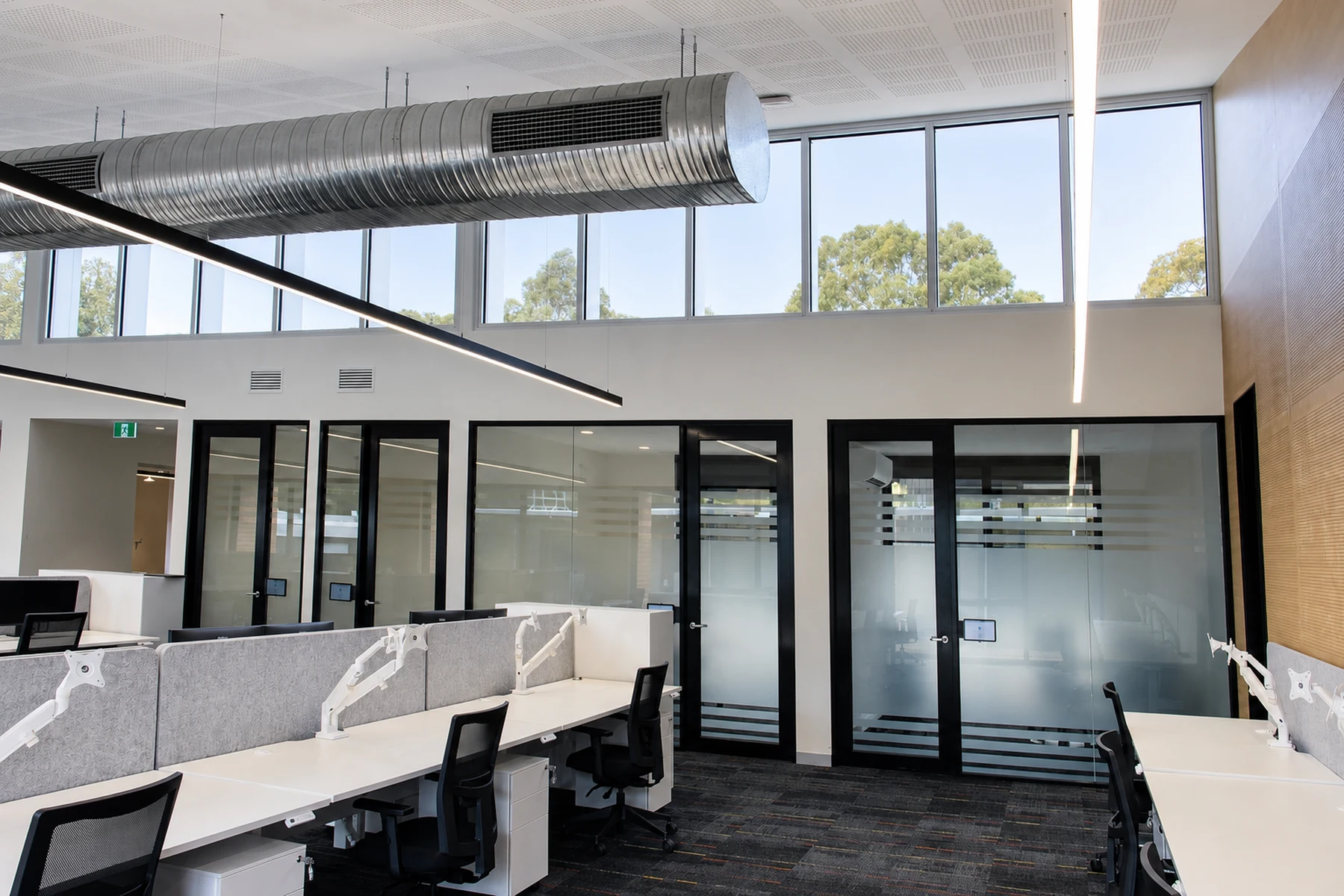 DEECA Broadford high-level glazing, exposed services and enclosed collaboration rooms