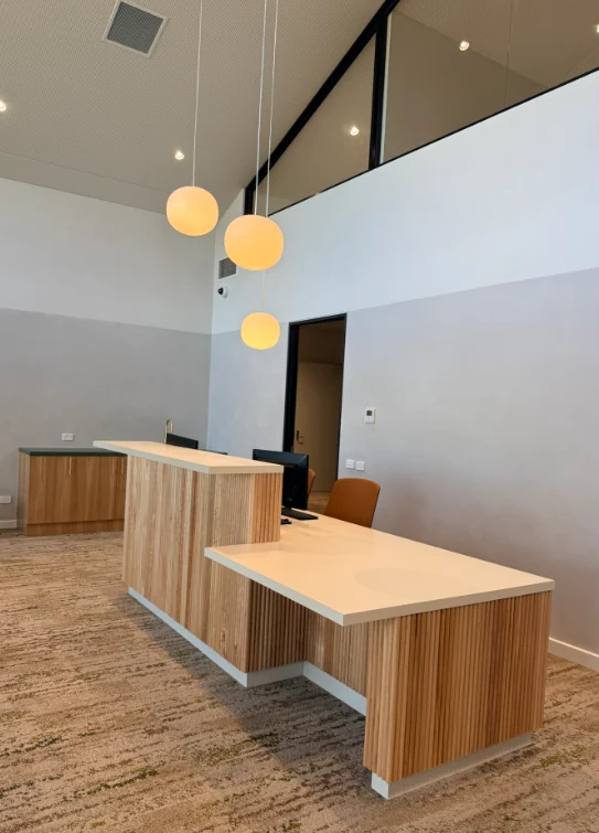 Completed timber reception joinery and pendant lighting