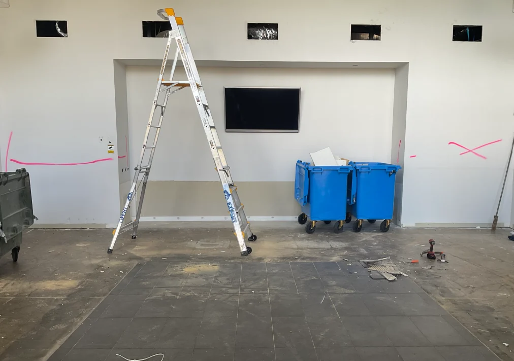 Existing visitor services wall during refurbishment and services coordination